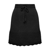 Close up of black mini skirt with crochet and scallop details.