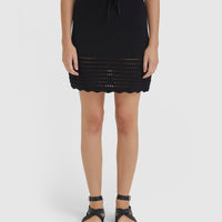 Close-up of Margot black mini skirt in wool blend with crochet hem detail.