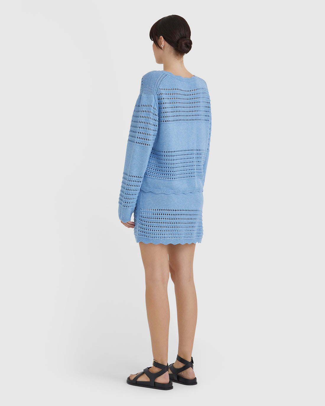 delicately crocheted sweater with intricate cut-out detailing.