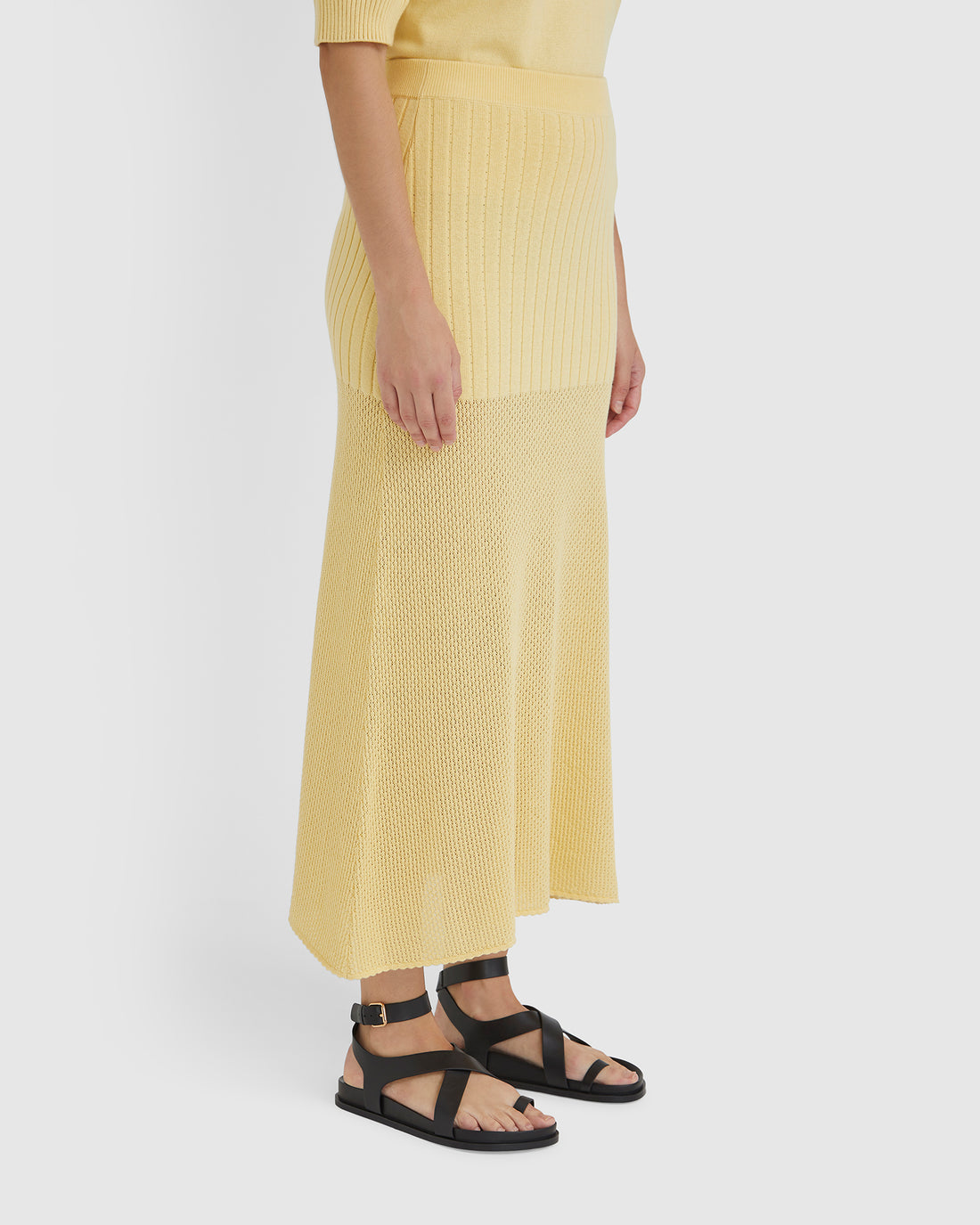 Close-up of maize maxi wool skirt in a wool blend with pointelle details.